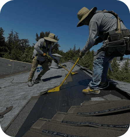 Two men working on a roof with a yellow tool.