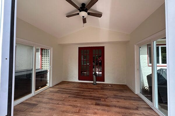 A room with wood floors and white walls.