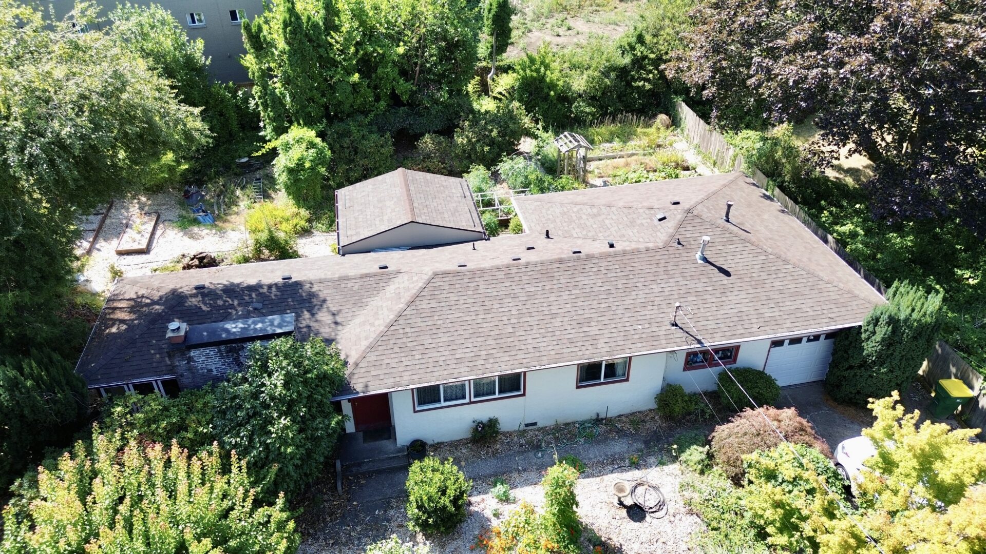 A house with a lot of trees and bushes