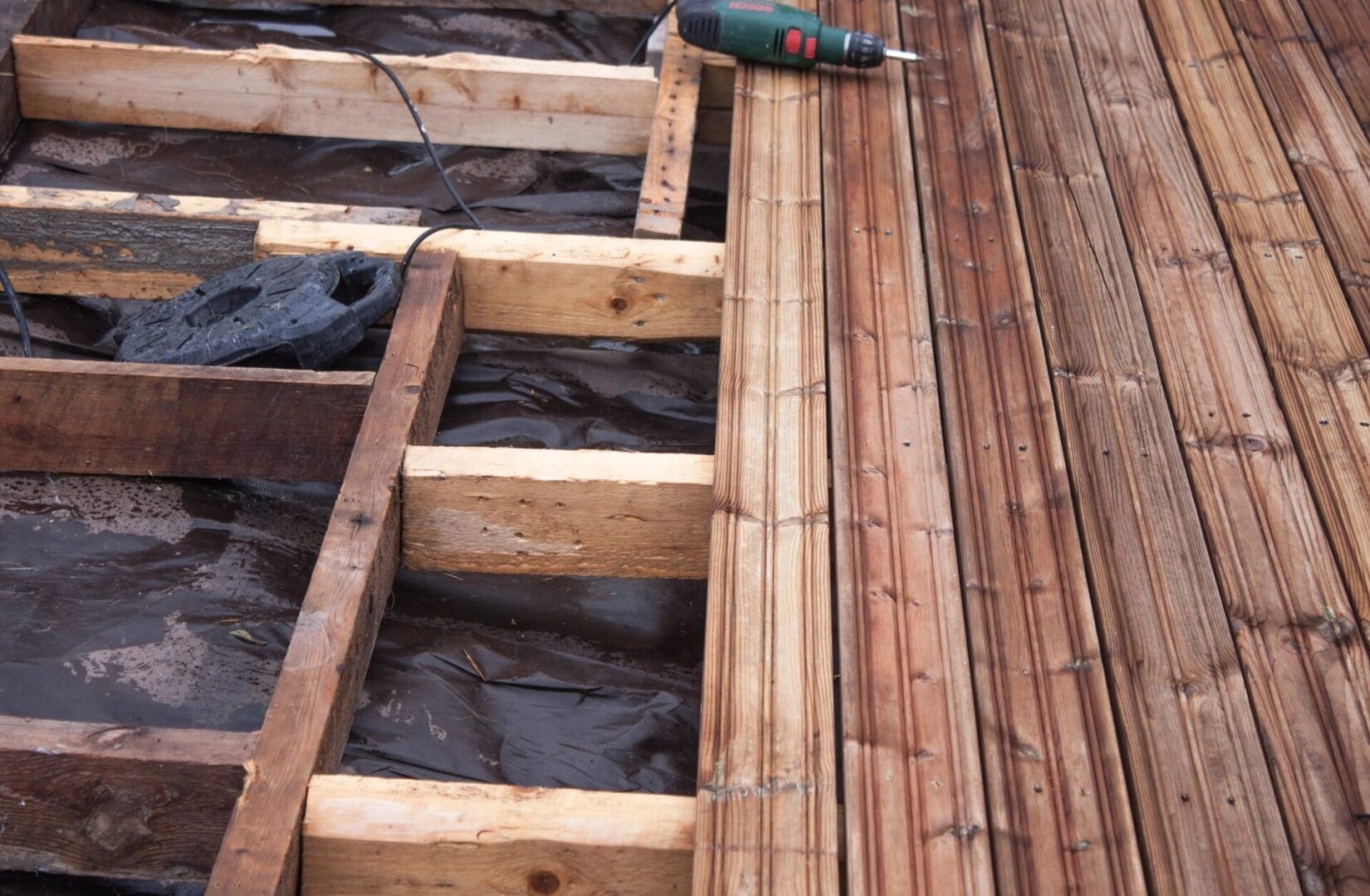 A wooden deck being built with wood decking