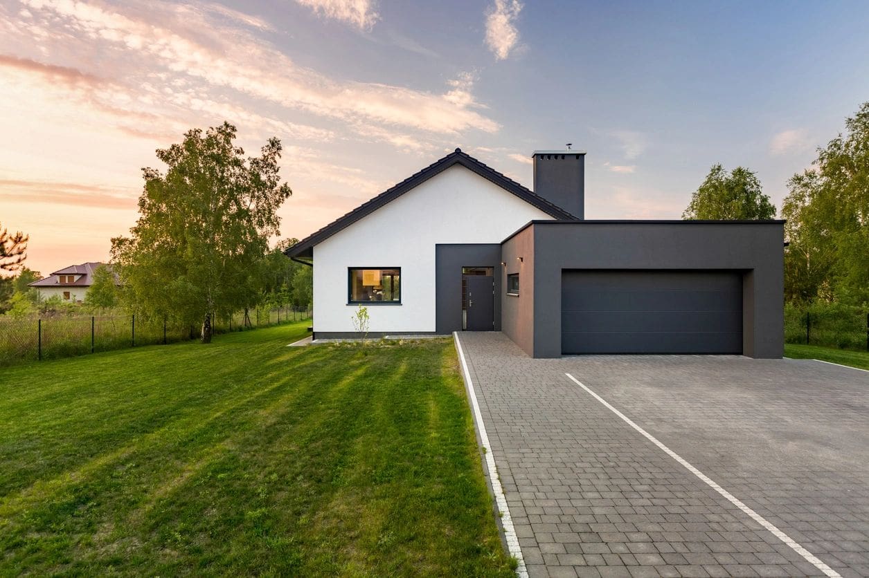 A house with grass and trees in the background.