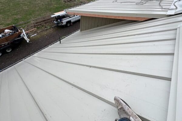 A person is standing on the roof of a building.